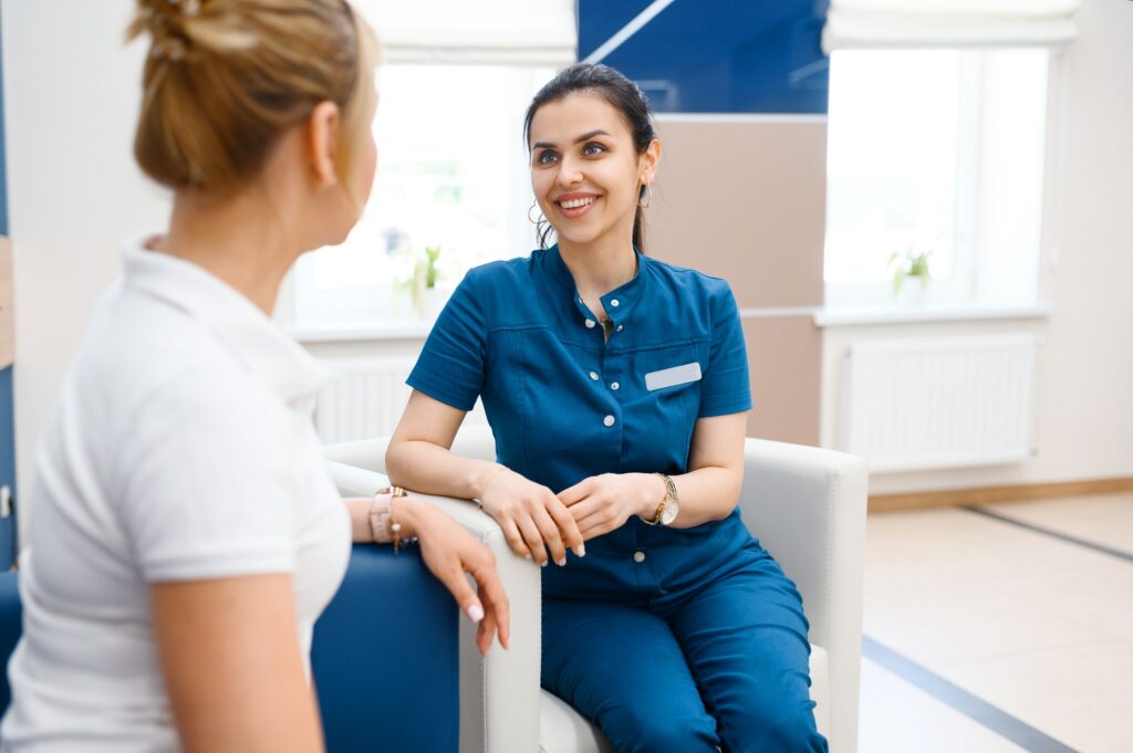 Two female doctors talking in clinic hall